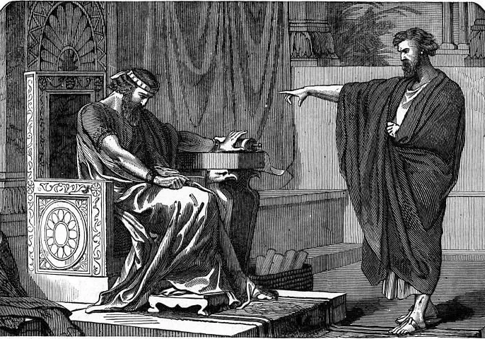 A man sitting on a throne holds his head, while another man standing in front of him points and speaks, with a background of elaborate architecture.